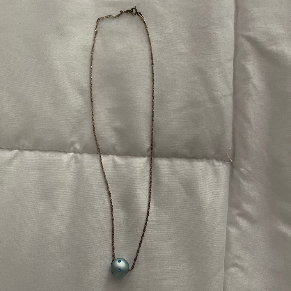 Single blue rolling bead necklace